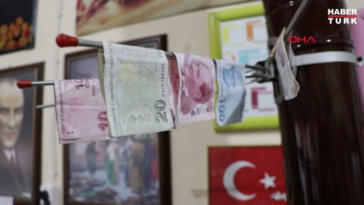 Paraları dezenfektanla yıkayıp, sobada kurutuyor
