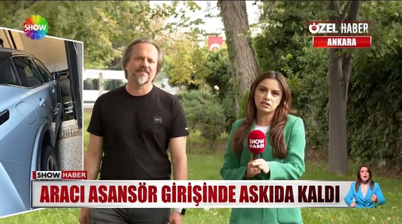 Arabasıyla, araç asansöründe asılı kaldı!