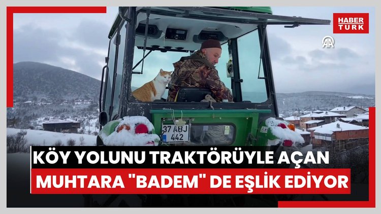 Kapanan köy yolunu traktörüyle açan muhtara "Badem" de eşlik ediyor