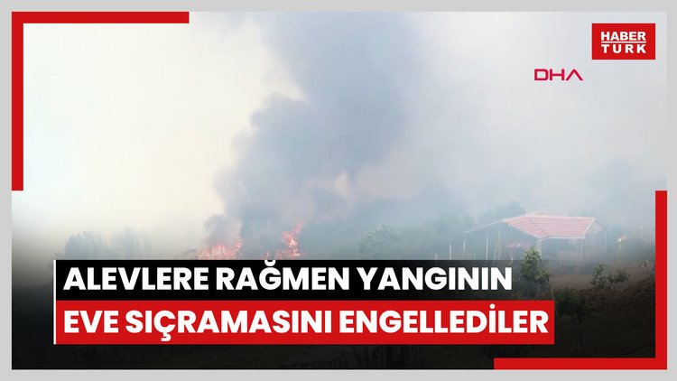Üzerlerine ilerleyen alevlere rağmen yangının eve sıçramasını engellediler; o anlar kamerada