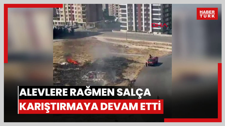 Alevlere rağmen salça karıştırmaya devam etti