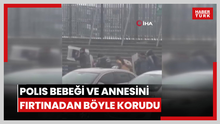 Yürekleri ısıtan görüntüler: Polis kalkanı bebeği ve annesini fırtınadan böyle korudu